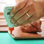 フローリングの実に木工用ボンドを塗布している写真
